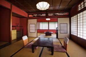 a dining room with a table and chairs in a room at Motoyu Ishiya in Kanazawa