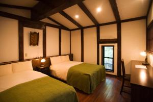 A bed or beds in a room at Motoyu Ishiya