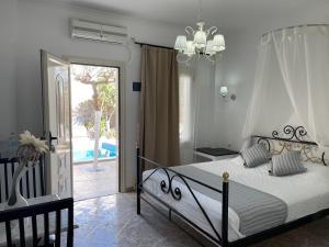 a bedroom with a bed and a view of a pool at Danae Villa in Fira