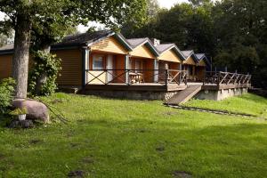 a row of houses in a yard with a grass field at Suurejõe Holiday Center in Suurejõe