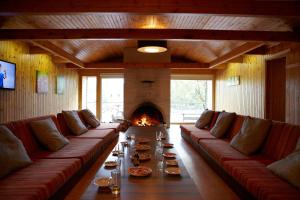 a living room with a long couch and a fireplace at Suurejõe Holiday Center in Suurejõe