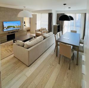 a living room with a couch and a table at Residence Carlton Riviera in Cannes