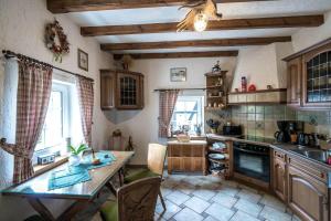 a kitchen with a table and a counter top at Jagdhaus-Stift-Ennenbach in Ruppichteroth