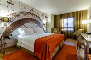 a hotel room with a large bed with a stone wall at Hotel Marques De Pombal in Lisbon