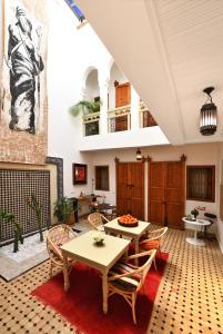 a living room filled with furniture and a table at Riad Lamzia in Marrakesh