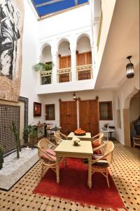 a living room filled with furniture and a large window at Riad Lamzia in Marrakesh