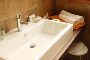 a white sink in a bathroom with a counter at Bed and Breakfast Flumen in Gorizia