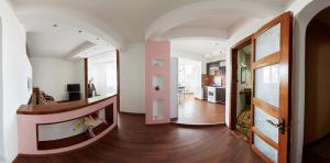a hallway of a home with a staircase and a living room at Babylon Apartment on Bukovinskaya Street in Rivne