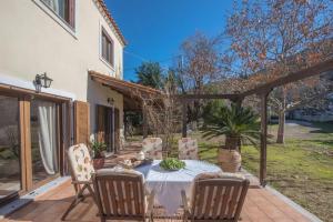 a patio with a table and chairs on a patio at Gerania Villa in Písia