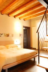 a bedroom with a large bed with a wooden ceiling at Bed and Breakfast Flumen in Gorizia