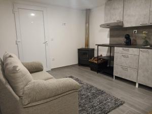 a living room with a couch and a kitchen at Casinhas da Lu in Geres