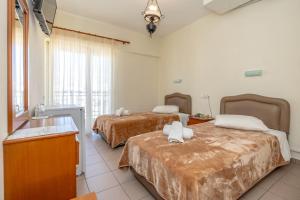 Ένα ή περισσότερα κρεβάτια σε δωμάτιο στο Hotel Alkyon