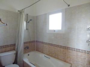 a bathroom with a tub and a toilet and a window at Villa Isabella: Coral Bay Beach, Seaview in Peyia +5 photos