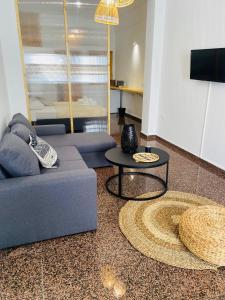 a living room with a couch and a table at Homdwell Fine Living 1 in Ermoupoli