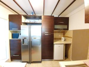 a kitchen with a stainless steel refrigerator at Apartments Dabar in Dubrovnik