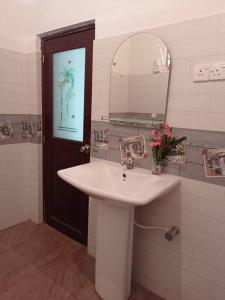 a bathroom with a sink and a mirror at Saubagya Residence - Air Port View in Anuradhapura