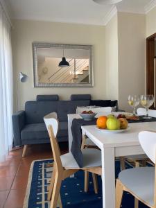 a living room with a table and a dining room at Casas dos Seixos in Moledo