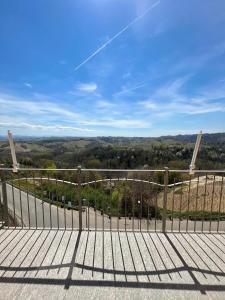a walkway with a fence and a view at Belvedere Bike Hotel in Montà