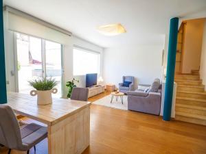 a living room with a table and a couch at Elite Bonaire Penthouse by Hello Homes Sitges in Sitges +28 photos
