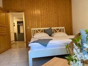 a bedroom with a bed with white sheets and pillows at Kapitänshaus in Bad Schandau