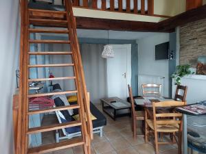 a room with a loft bed and a dining room at Studio Bellevue 3 rue du bourg a Montastruc 47380 entrée indépendante in Montastruc