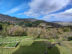 un champ avec une clôture et des montagnes en arrière-plan dans l'établissement Affittacamere Le Ciboline, à Beverino