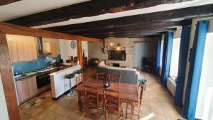 a kitchen and dining room with a table and chairs at Le Grand Domaine du Rocher in Bonnemain