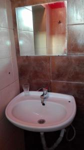 La salle de bains est pourvue d'un lavabo et d'un miroir. dans l'établissement 1 room in Nikea Park apartaments, aux Sables d'or