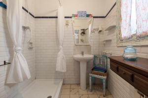 a white bathroom with a sink and a shower at El Patio de Gracia in Barcelona +11 photos