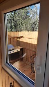 a view of a patio from a window of a tiny house at Zirkuswagen Glamping für 2 mit Veranda Küche Netflix Parken und Hofladen in Steinhöfel