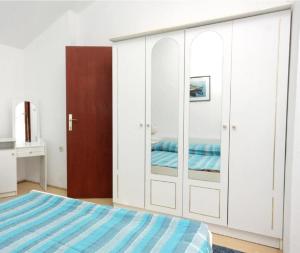 A bed or beds in a room at Apartments Let - 5 m from sea
