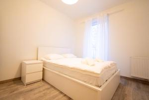 Posteľ alebo postele v izbe v ubytovaní Apartament Charlie