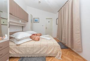 a bedroom with a bed in a room with a window at Apps and room Goran in the center in Makarska