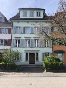 a large white house with a door in front at Casa Koraal - Old Town Zug in Zug