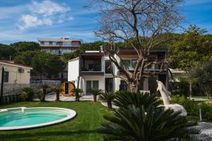 a villa with a swimming pool in front of a house at Luxury B&B La Riserva Dannunziana in Pescara