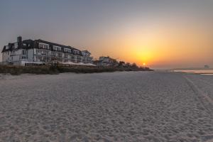 a view of the beach at sunset at Mein Strandhaus - Hotel, Restaurant & Schwimmbad in Timmendorfer Strand