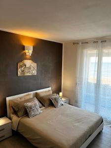 a bedroom with a large bed and a window at HOLIDAY HOME AURORABIO- locazione turistica breve in Tre Fontane