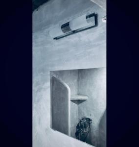 a bathroom with a urinal and a light on the wall at Giagia Annousio in Dhriopís
