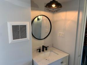a bathroom with a sink and a mirror at County Cove - Picton Suite in Wellington
