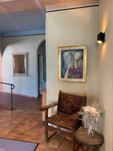 a room with a chair and a painting on the wall at Hotel Belvedere in Calvi