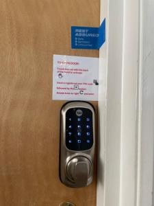 a remote control sticking out of a door with a sign at Guest Lodge Penzance in Penzance