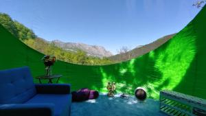 a living room with a green screen with a couch at Sineva in Vratsa