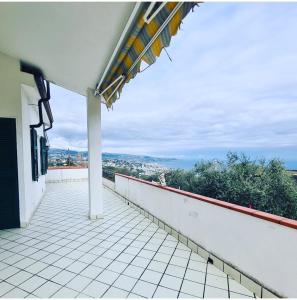 a balcony of a house with a view of a city at BBQ HOUSE in Sanremo