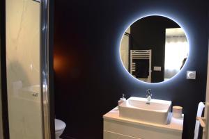 a bathroom with a sink and a mirror at La Bâtie - Terrasse avec Vue imprenable sur le Rhône, 3 chambres, 3 salles de bain in Tain-lʼHermitage