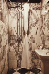 a bathroom with a shower curtain and a sink at House of Gods Royal Mile in Edinburgh