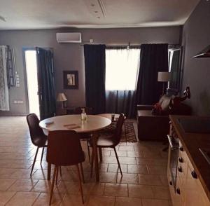 a kitchen and living room with a table and chairs at Ambrosia in Tinos