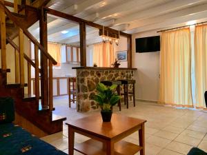 a living room with a table and a fireplace at Dimarion Villas in Agios Nikitas