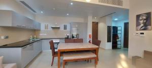 a kitchen with a table and chairs in a room at ONE Elegant Apartment in Muscat Bay 02 in Muscat