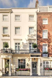 a large white building with a balcony at The Tophams Hotel in London