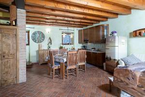 a kitchen with a table and a refrigerator at COUNTRYHOUSE NOCINO - Regarda Travel in Lazise